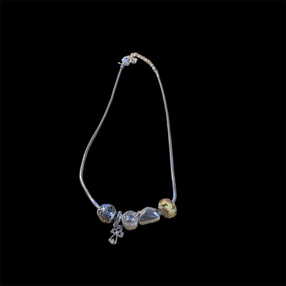 Avon silvertone charm necklace 19” length 5 charms adjustable length